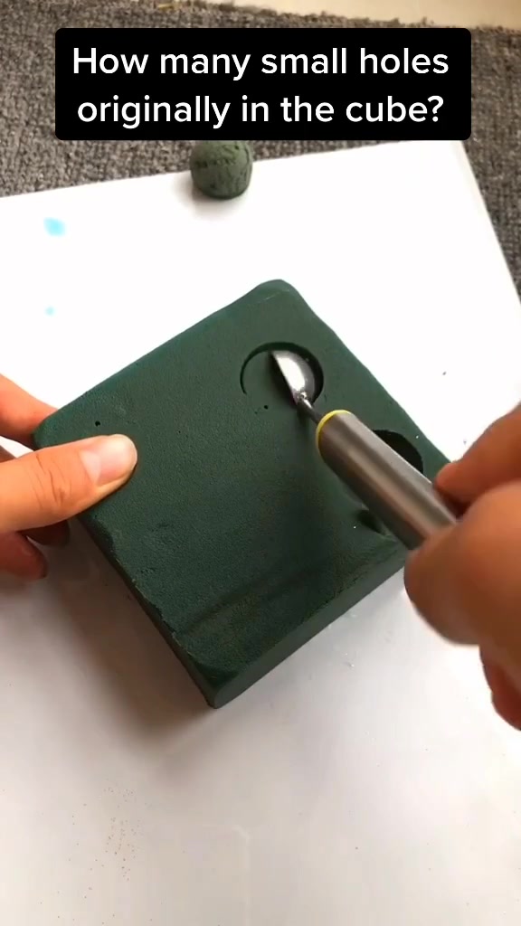 How many small holes originally in the cube?
