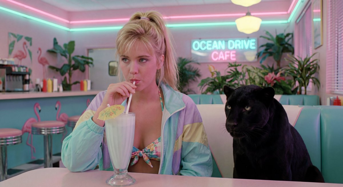 Cinematic photograph of a stylish young blonde woman in a bikini, with a black p